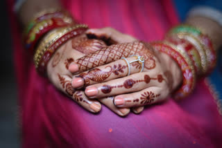 Indian Hindu woman hands with traditional black mehndi