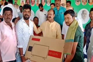 minister-kc-narayana-gowda-distributed-led-tv-to-gram-panchayat-candidates
