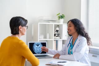 healthcare worker discussing with female patient