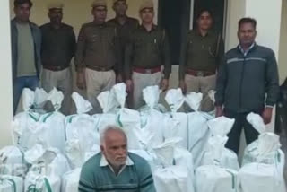 The accused with seized explosives at a Dausa police station