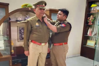 IPS Anoop Singh putting star on Father Janardan Singh's Uniform