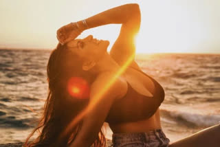 Actress Shama Sikander oozes comfort in a black sports bra with blue denim shorts. The actress posed on a sea beach and shared the picture on Instagram writing, "Sooraj ki Bahaon mein ab hai yeh zindagi."