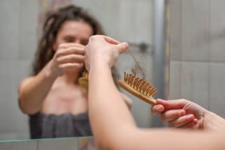 Young Upset Woman In Bathroom Holding comb With Hair
