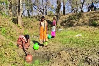 Tribals living by drinking water from the well