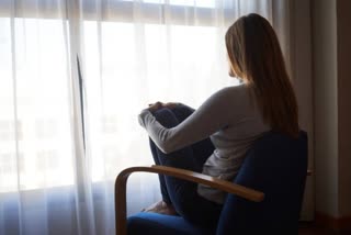 an woman sitting on the chair with dipression mood