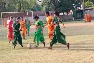 Women teams play football wear sarees