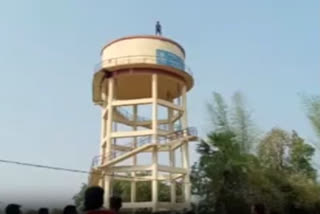 Pintu Harpal climbs up an overhead water tank at Balangir