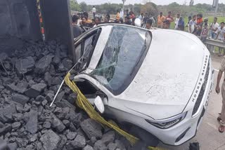 coal truck fell on car