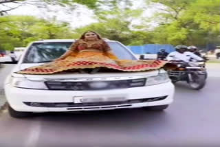 Cop fines woman for making reel while sitting on bonnet of moving car in Prayagraj