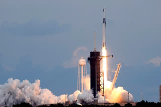 A SpaceX Falcon 9 rocket, with the Dragon capsule and a crew of four private astronauts lifts off from pad 39A