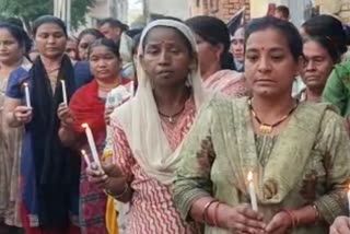 Relatives take out candle march