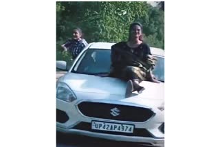 girl was stunts on the car bonnet in Ayodhya