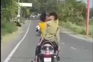 Two boys liplocked on moving scooty