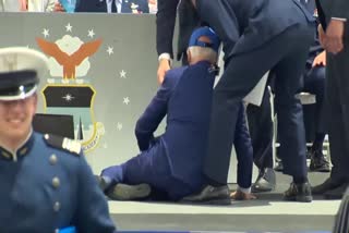 Biden trips and falls on stage