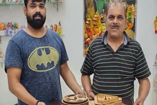 National Awardee Rameshwar Singh and son Rajkumar Singh with model of new parliament building
