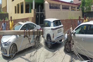 Two cars Damaged due to falling of Electric Poles