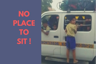 No place to sit inside; student balances on moving school van's footboard