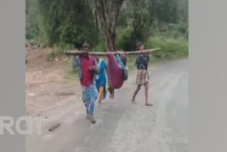 tribal-people-carried-the-woman-to-the-cradle-for-delivery