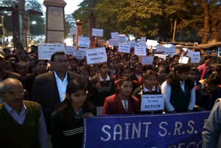 school students take out candle march