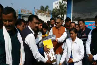 MLA distributed sports material to students