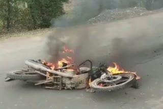 Burning bike in road accident