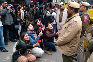 protester present roses to police