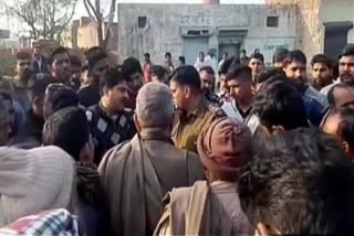 people protest in front of police station in karnal