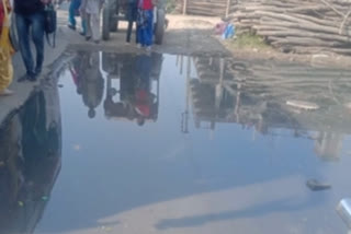 drainage water flowing in middle of road