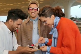 Deepika cuts birthday cake at the airport with Ranveer