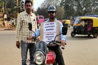 A civilian went on a bike rally with a board which written as "I do Support to Band"