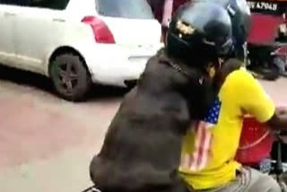 Dog 'wearing' helmet on bike ride in Chennai