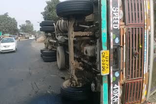 Truck full of clothes overturns