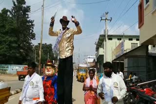 independent candidate innovative election campaigning in dubbaka with joker and tall man