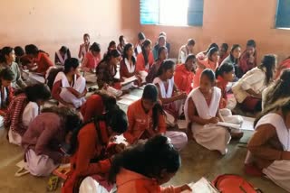 Students are taking exams sitting on ground in middle school palamu