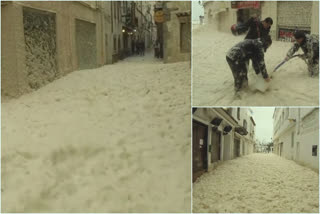 Various of high waves crashing in over Tossa de Mar beach, streets flooded with water and sea foam