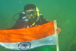 flag off by a scuba diver under the sea in dwarka