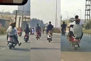 Youths Bike Wheeling on Airport Road