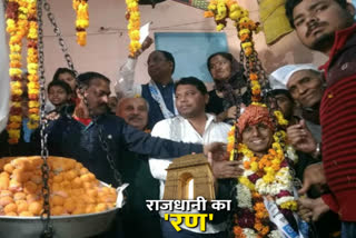 AAP candidate Naresh Yadav weighed with laddus in Mehrauli assembly