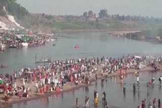 Devotees dip their faith in Narmada