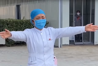 Nurse treating coronavirus patients mimes a hug to her daughter