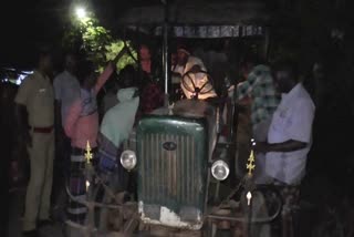 People hold  sand theft tractor