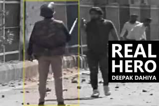 unarmed police constable deepak man seen aiming gun at him in delhi violence