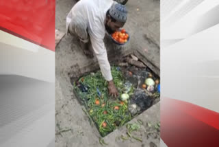 Vendor washes vegetables in drainage water before selling them