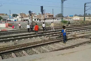 People cross the railway track on foot at Nangloi railway station