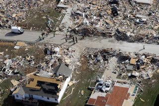 Emergency personnel work among destroyed homes Tuesday, near Cookeville, Tenn.