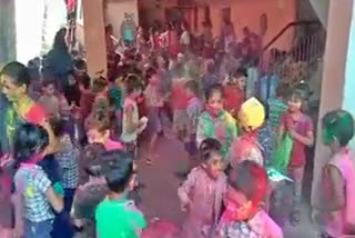 Innocent children immersed in holi colors