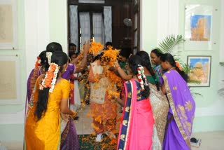 Puducherry Governor Kiran Bedi plays with flowers at Raj Bhawan