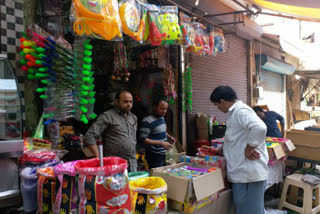 people shopping for holi festival in nuh