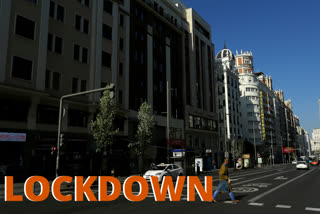 A man crosses a pedestrian crossing at the Gran Via avenue in downtown in Madrid, Spain, on Saturday.