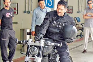 Dhoni rides a bike on the streets of Jharkhand
